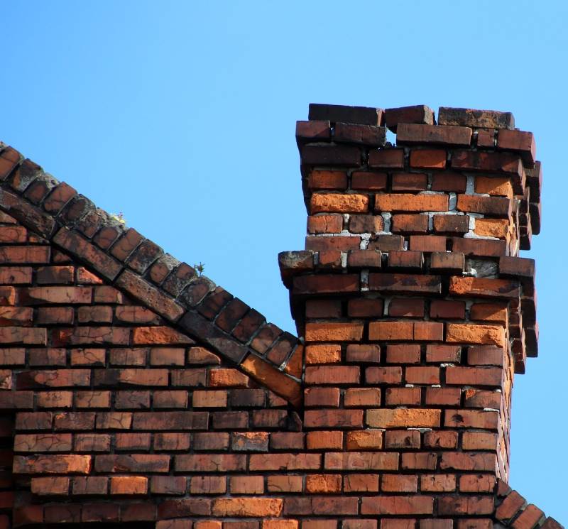 Damaged chimney on an Cary home showing cracks and missing mortar